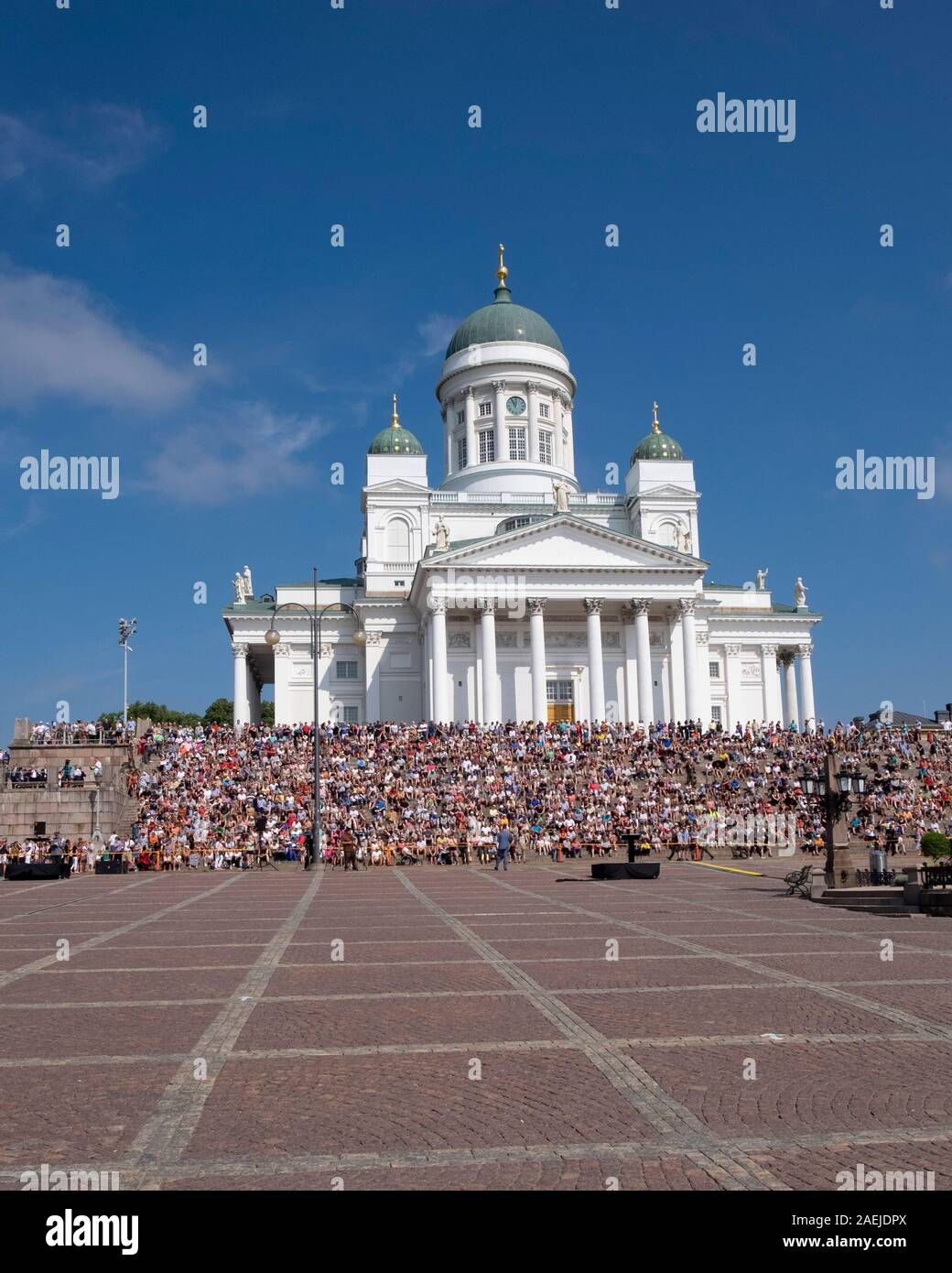 View across Senate Square of people sitting on the steps of the Helsinki Cathedral, Helsinki, Finland, Scandinavia,Europe Stock Photo
