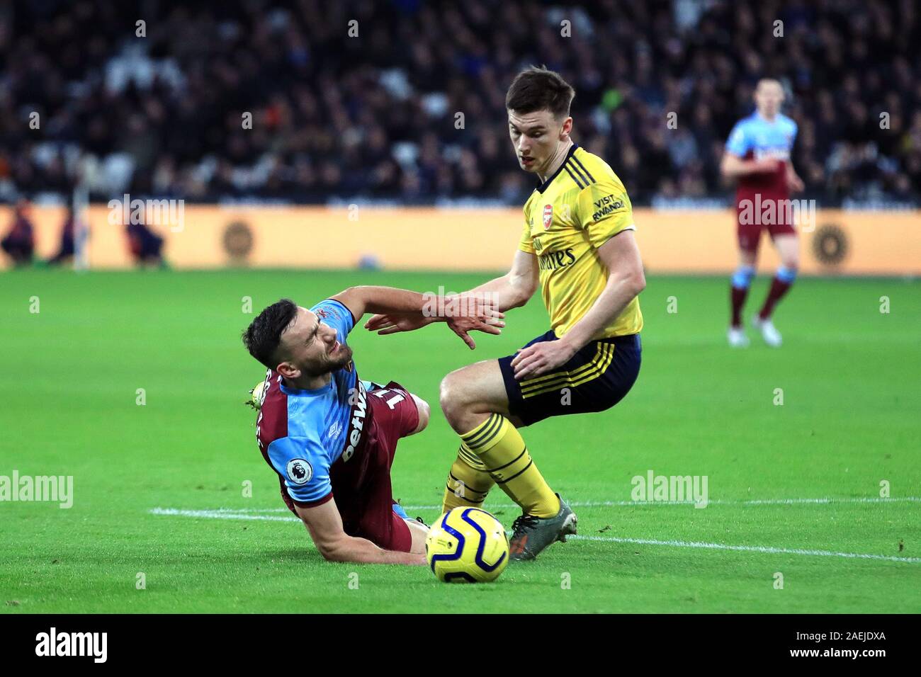 West Ham United's Robert Snodgrass (left) and Arsenal's Kieran Tierney battle for the ball during the Premier League match at the London Stadium, London. Stock Photo