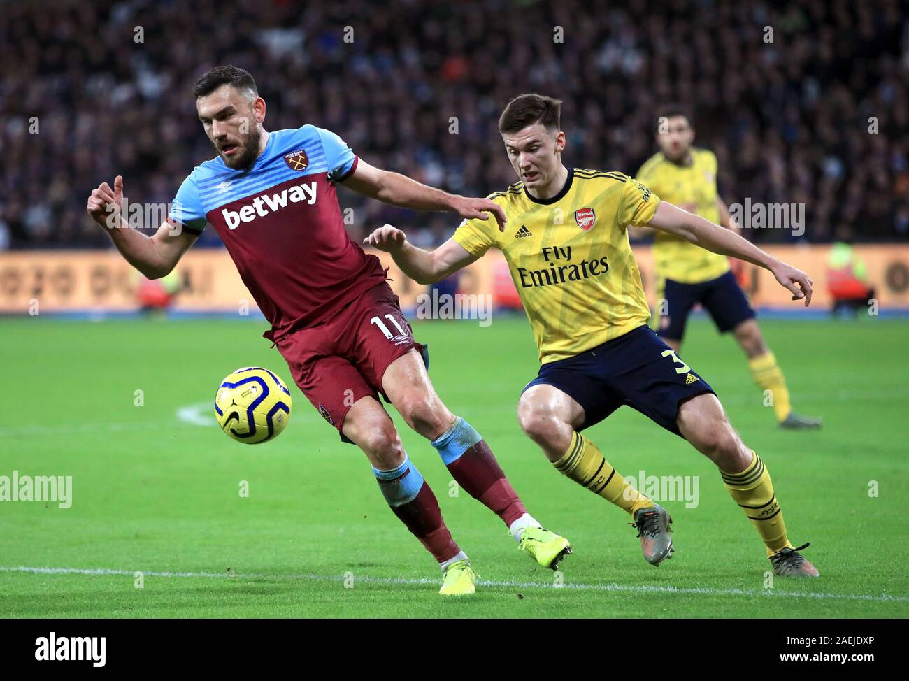 West Ham United's Robert Snodgrass (left) and Arsenal's Kieran Tierney battle for the ball during the Premier League match at the London Stadium, London. Stock Photo