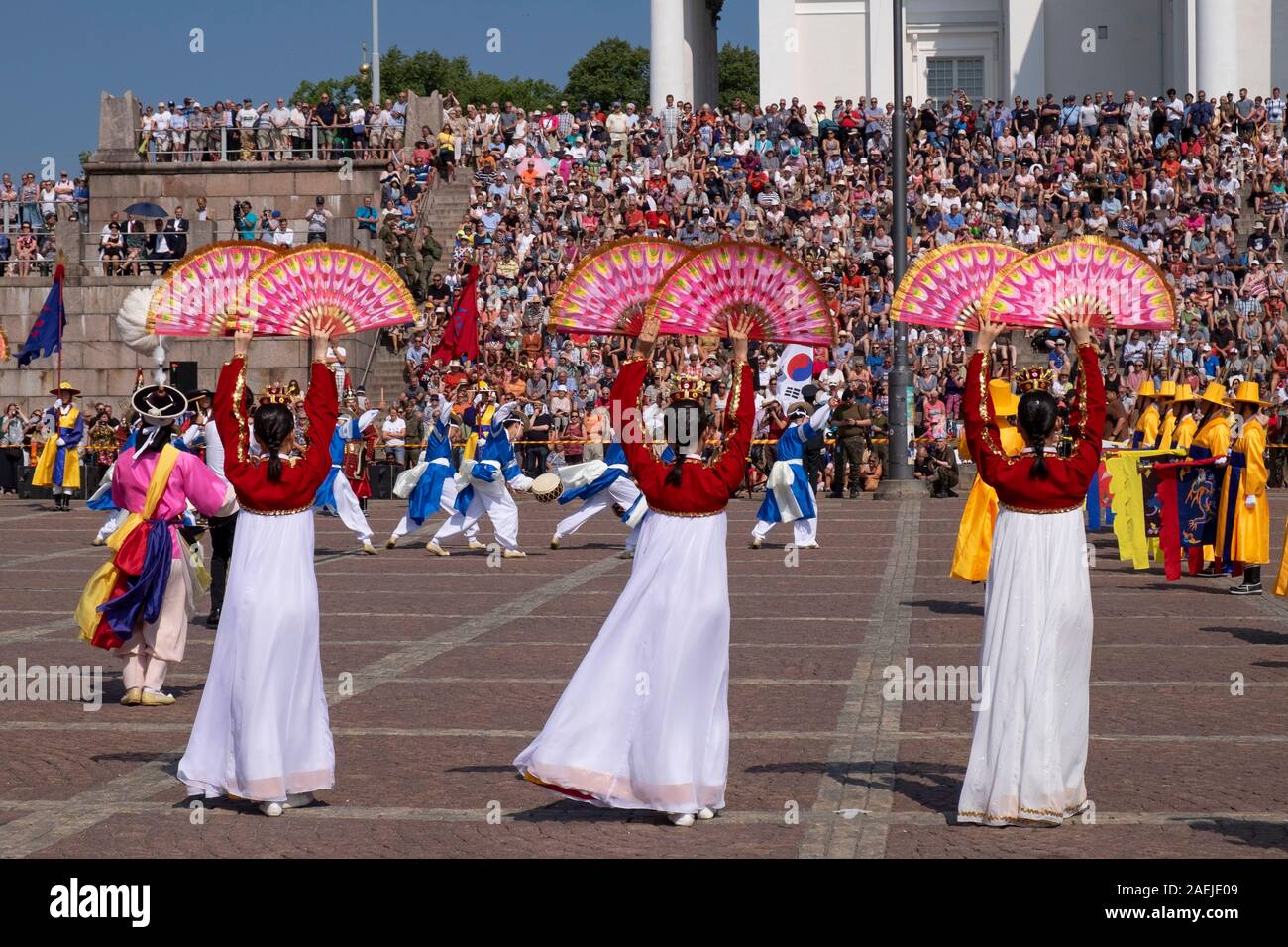 View across the Senate Square towards South Korean military band and people sitting on the steps of the Lutheran Cathedral, Helsinki,Finland,Scandinav Stock Photo