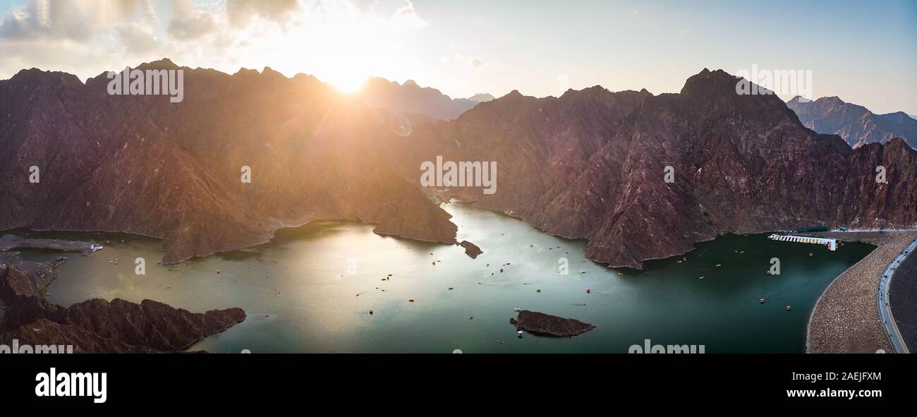 Sunset over Hatta dam lake in Dubai emirate of UAE aerial panoramic view Stock Photo