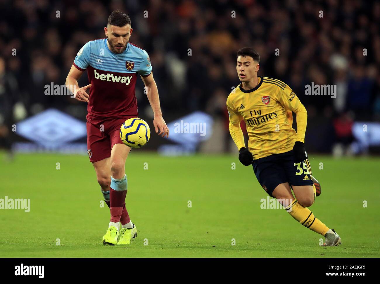 West Ham United's Robert Snodgrass (left) and Arsenal's Gabriel Martinelli battle for the ball during the Premier League match at the London Stadium, London. Stock Photo