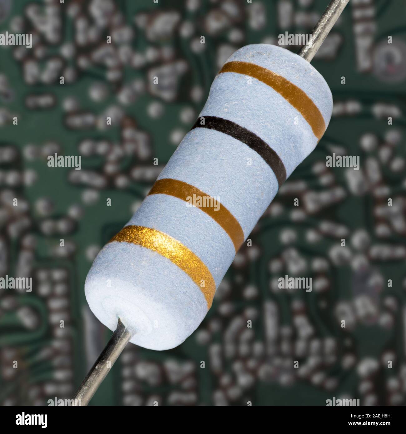 Resistor in front of a Circuit board that shows signs of age and