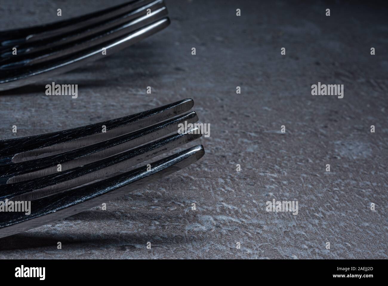 close up of the teeth of an aged shiny scratched fork Stock Photo