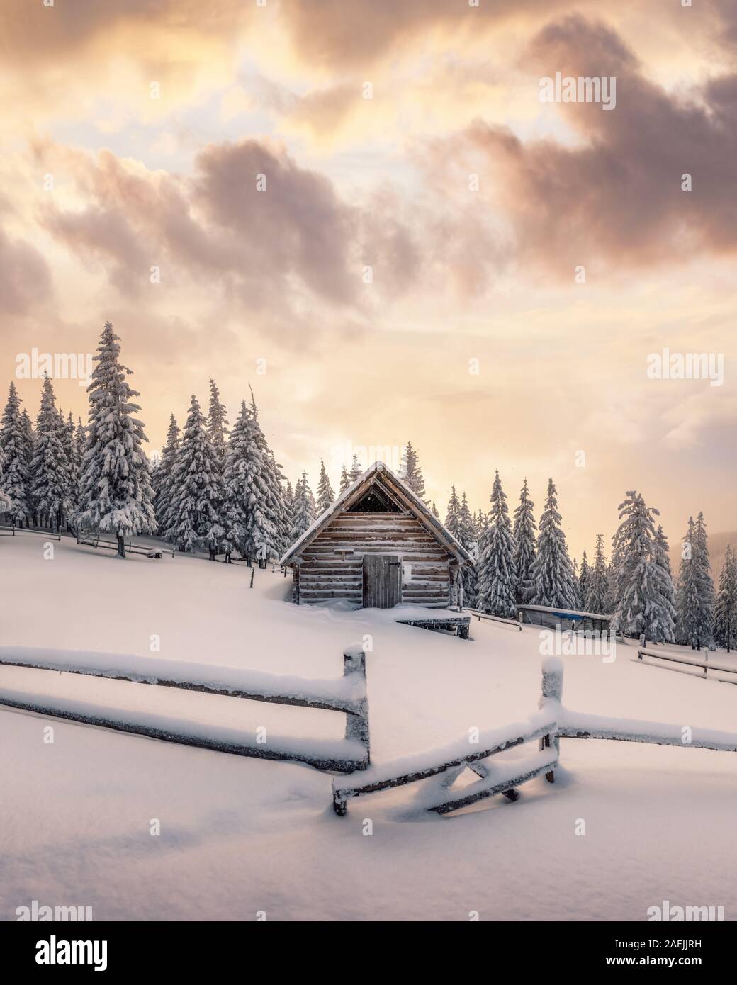 Fantastic winter landscape with wooden house in snowy mountains. Christmas holiday concept. Carpathians mountain, Ukraine, Europe Stock Photo