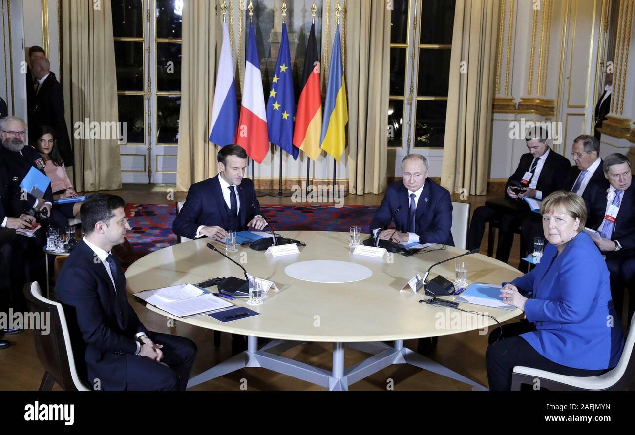 Paris, France. 09th Dec, 2019. The leaders of Ukrainian, France, Russia and Germany take their places for the start of the Normandy Format Summit meeting at the Elysee Palace December 9, 2019 in Paris, France. Sitting from left to right are: Ukraine President Vladimir Zelensky, French President Emmanuel Macron, Russian President Vladimir Putin and German Chancellor Angela Merkel. Credit: Alexei Nikolsky/Kremlin Pool/Alamy Live News Stock Photo