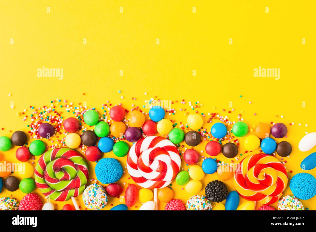 Download Colorful Candies Over Yellow Background Top View Flat Lay Copy Space Sweet Mix For Birthday Or Candy Shop Stock Photo Alamy PSD Mockup Templates