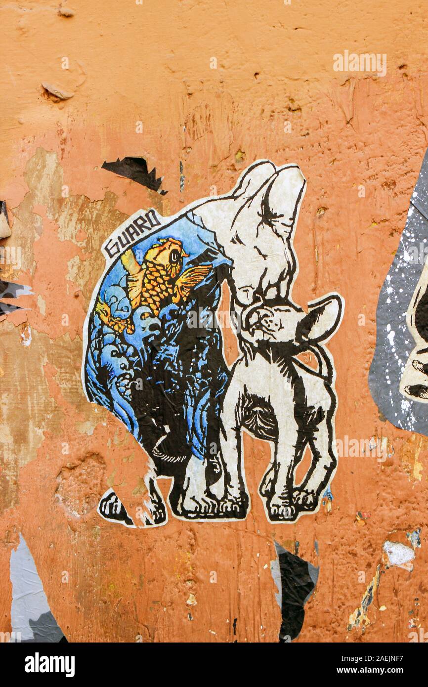 Cuttoshape pasteup poster art by Guaro on wall in Trastevere