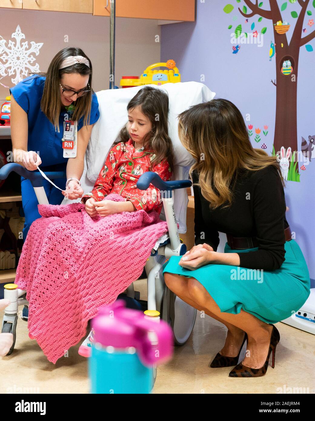 U.S First Lady Melania Trump hands out Be Best gifts during a visit with  young patients after reading, the children's book Oliver the Ornament Meets  Belle during a Christmas visit to Children's
