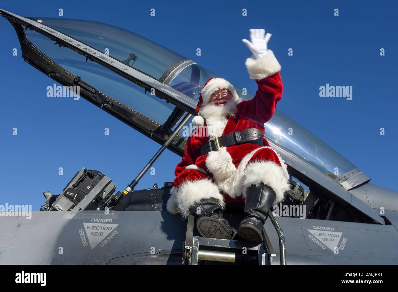 Santa Claus waves to service members and their families as he arrives in a U.S. Air Force F-16 Fighting Falcon fighter jet at McEntire Joint National Guard Base December 7, 2019 in Hopkins, South Carolina. Stock Photo