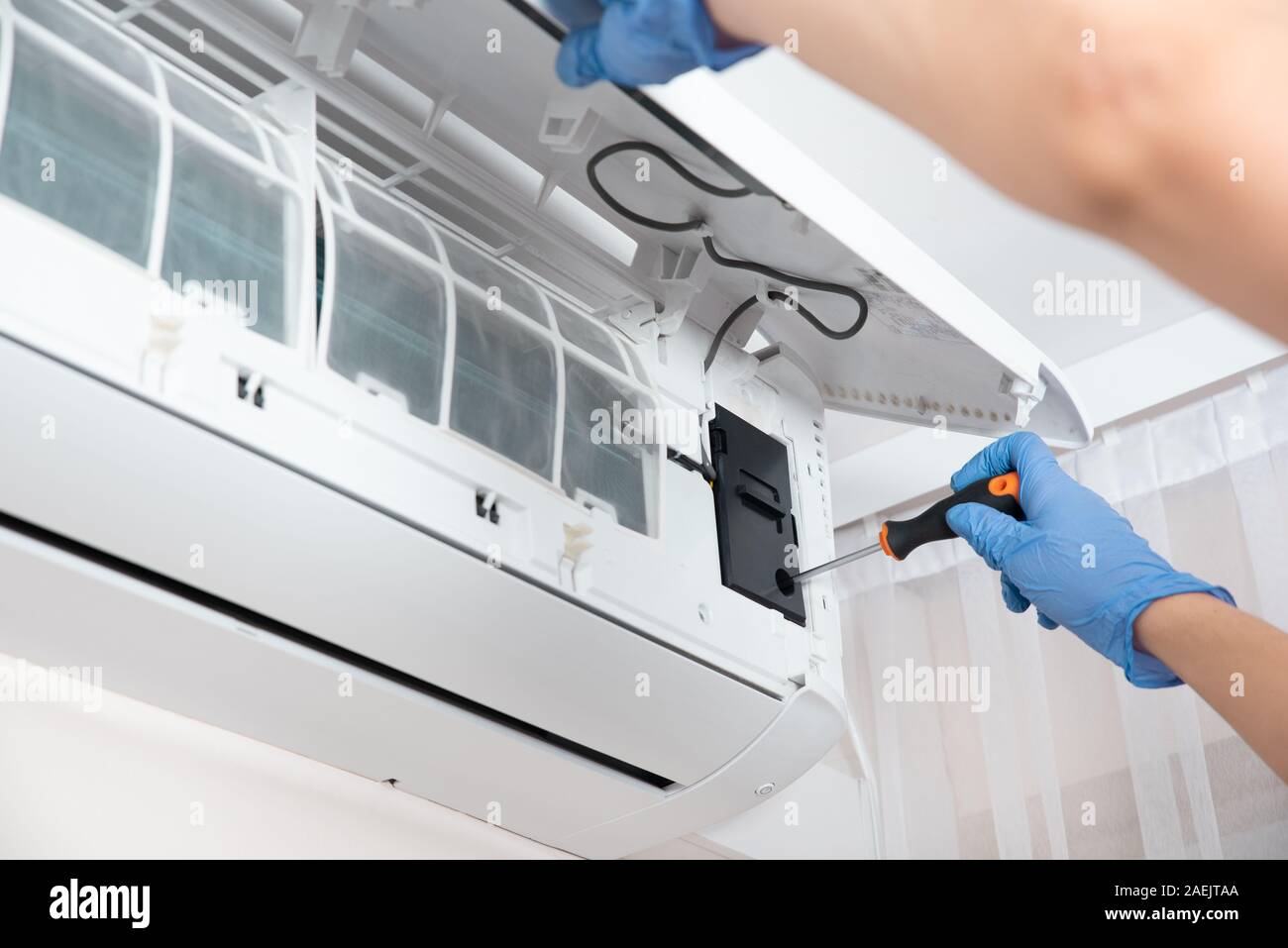 Modern air conditioner unit service. Cleaning the filter, fumigation ...