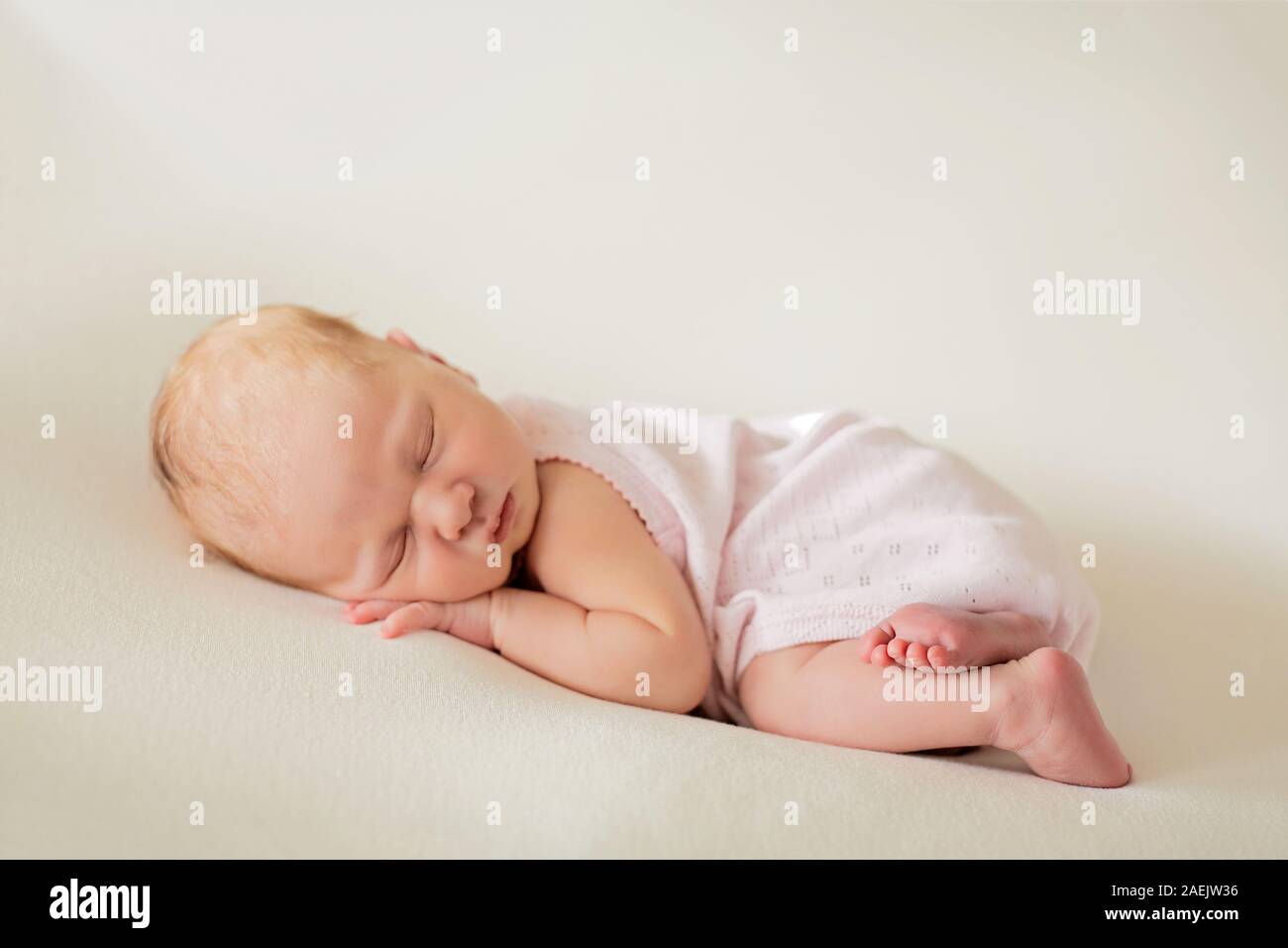 Sleeping newborn baby girl on a blanket. Baby goods packaging template Stock Photo