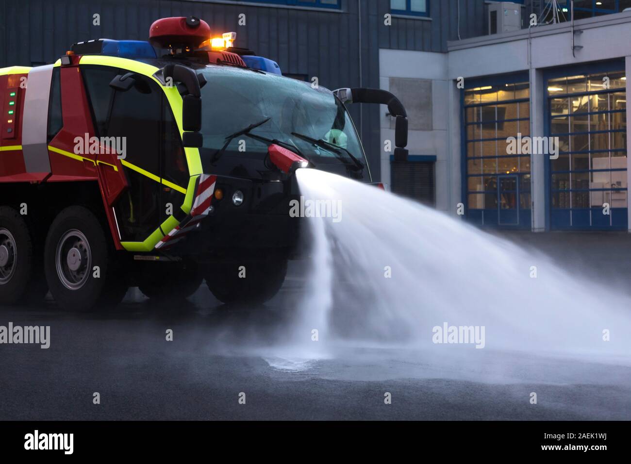 modern airport fire department fire engine clears with water Stock Photo