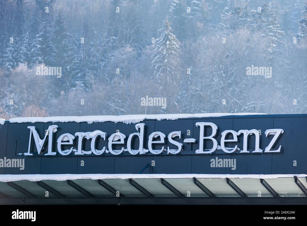 Mercedes Benz car brand logo on dealership showroom covered with snow. Haus im Ennstal, Steiermark, Austria Stock Photo