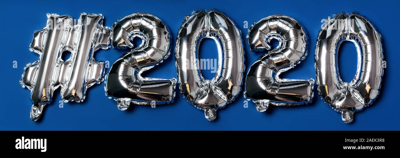 The inscription of hashtag letters 2020 on a blue background Stock