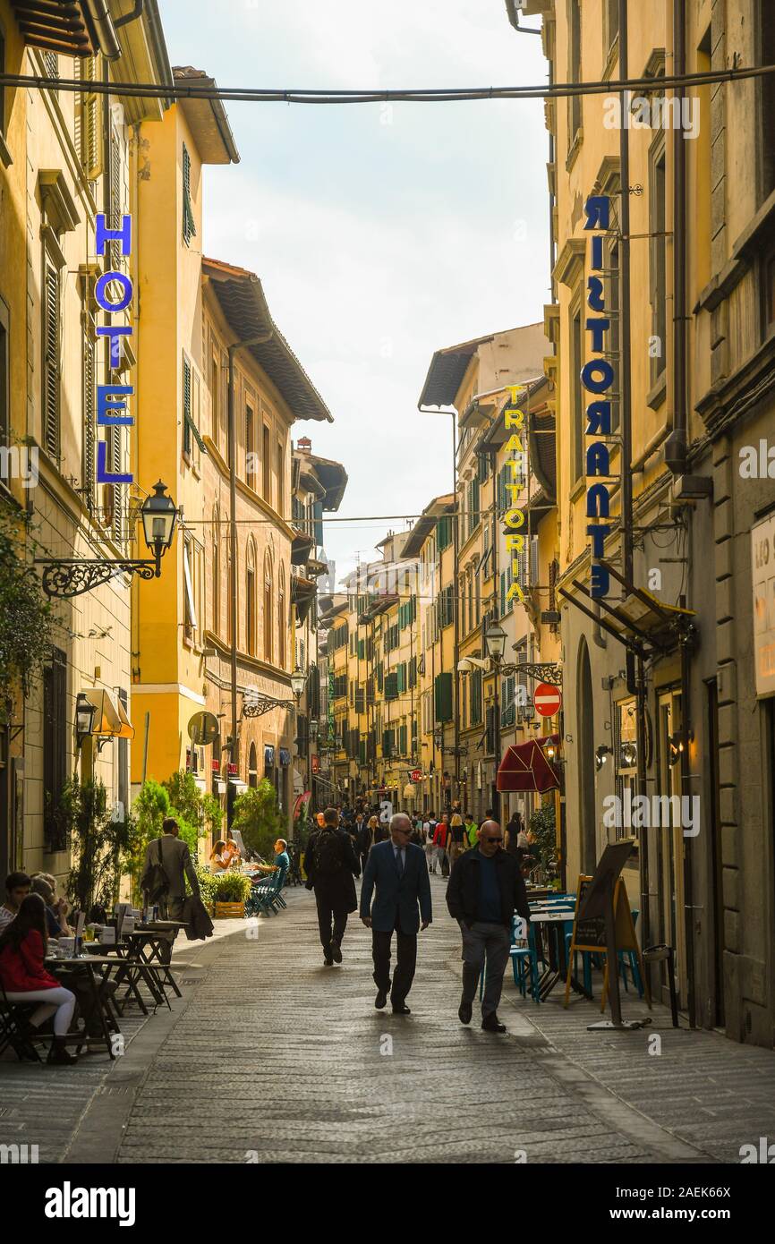 Street view of Via Faenza in the San Lorenzo district, historic centre of Florence, with people and tourists in sidewalk café, Tuscany, Italy Stock Photo