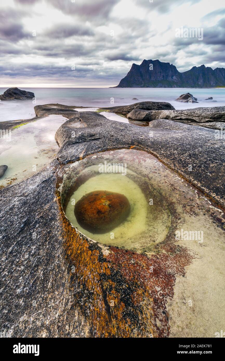 The dragon eye shaped rock at Uttakleiv Beach, Lofoten, the Norwegian  Arctic. Long exposure Stock Photo - Alamy