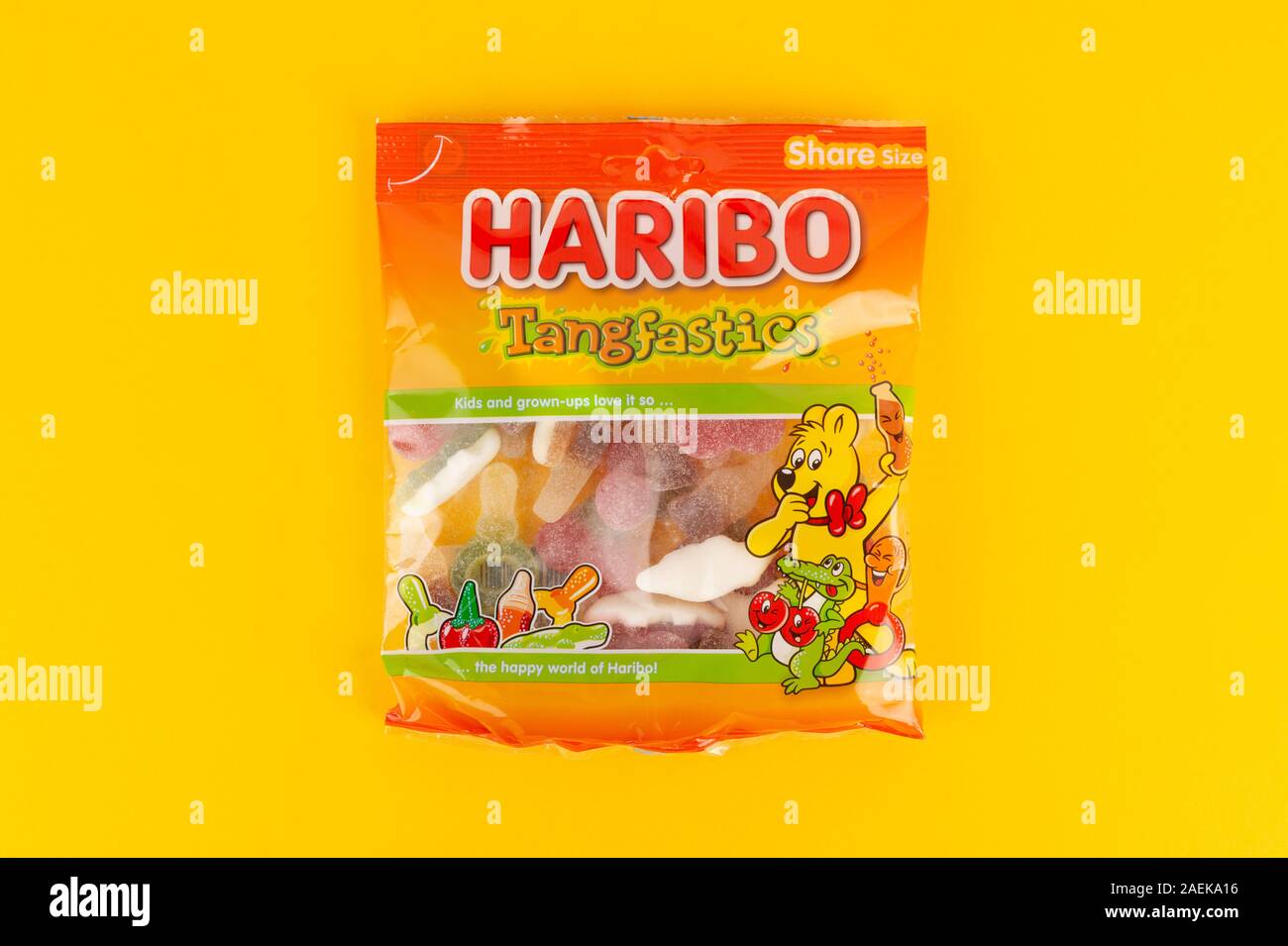 A packet of Haribo Tangfastics sweets shot on a yellow background. Stock Photo