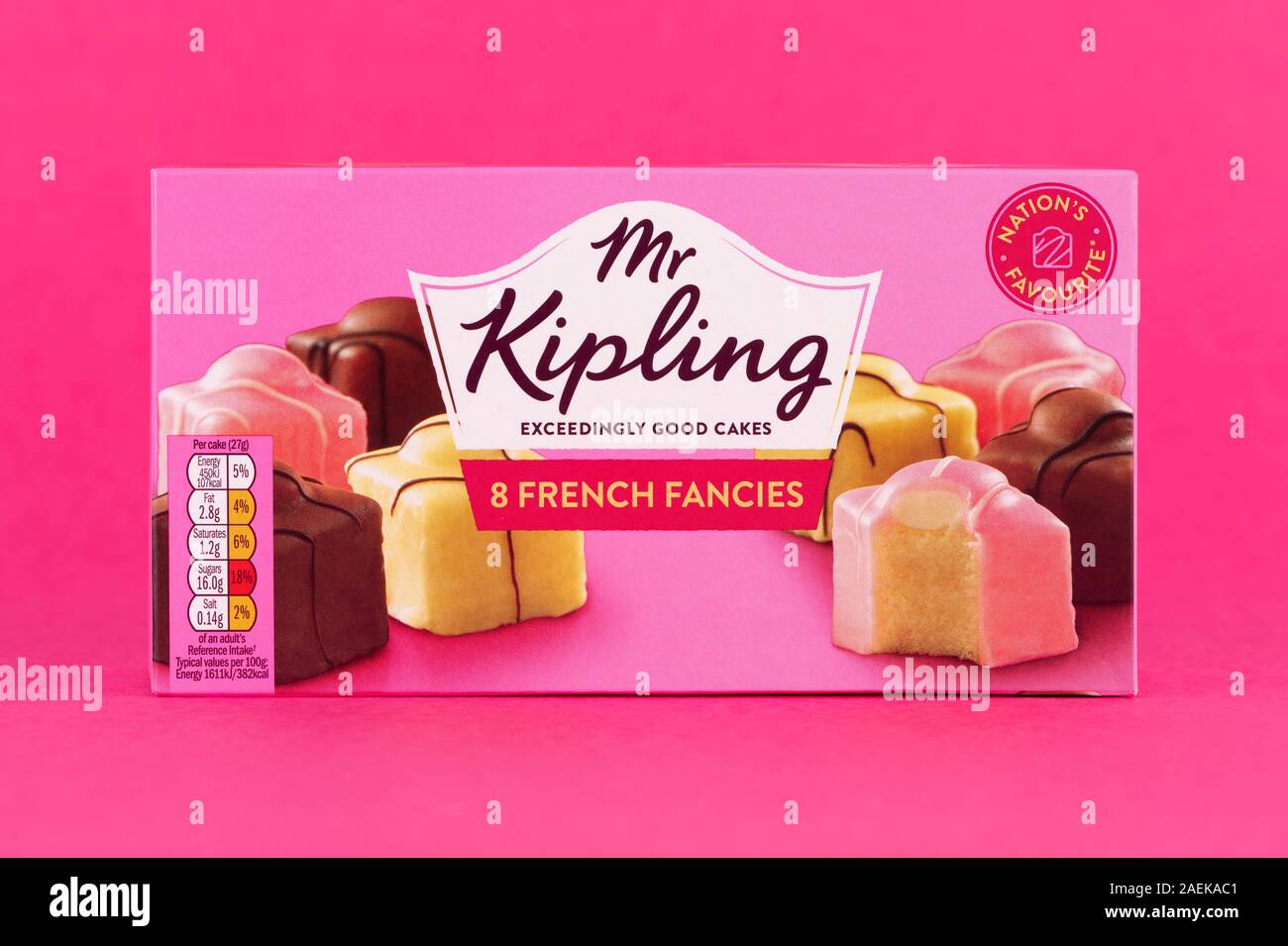 A box of Mr Kipling French Fancies shot on a pink background. Stock Photo