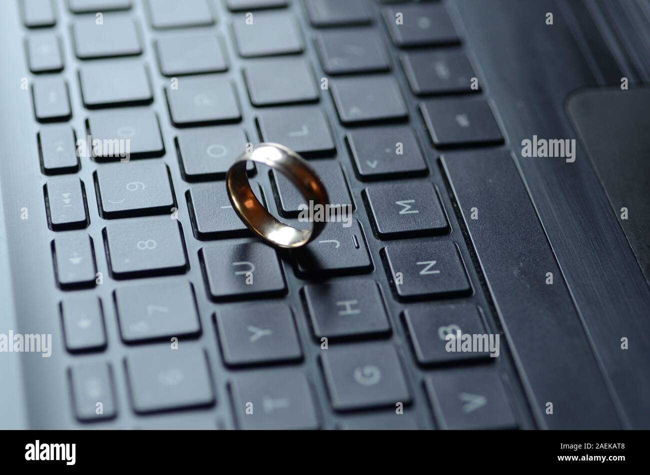 STARGATE: A gold ring appears on the keyboard of a laptop computer. Stock Photo