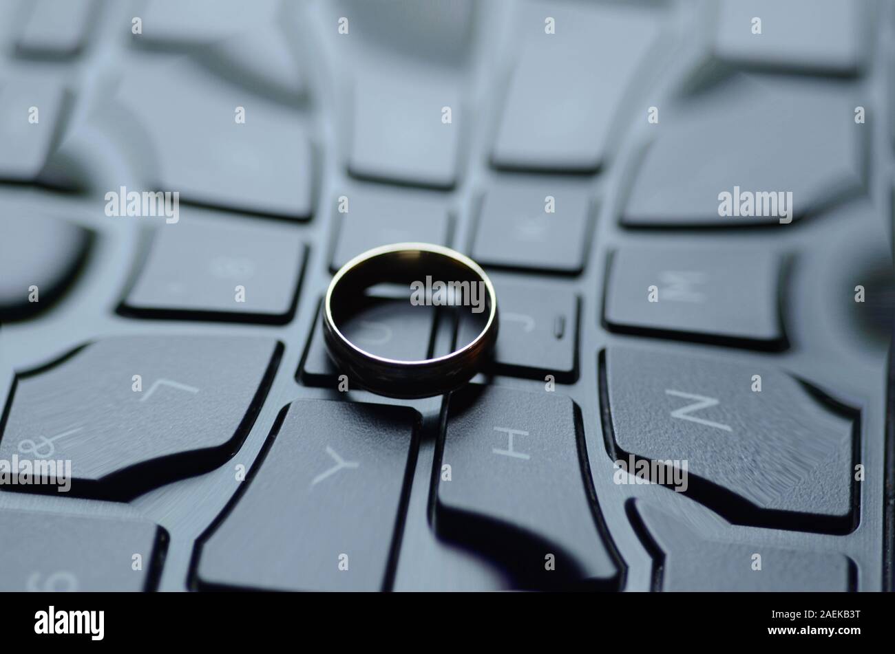 STARGATE: A gold ring appears on the keyboard of a laptop computer. Stock Photo