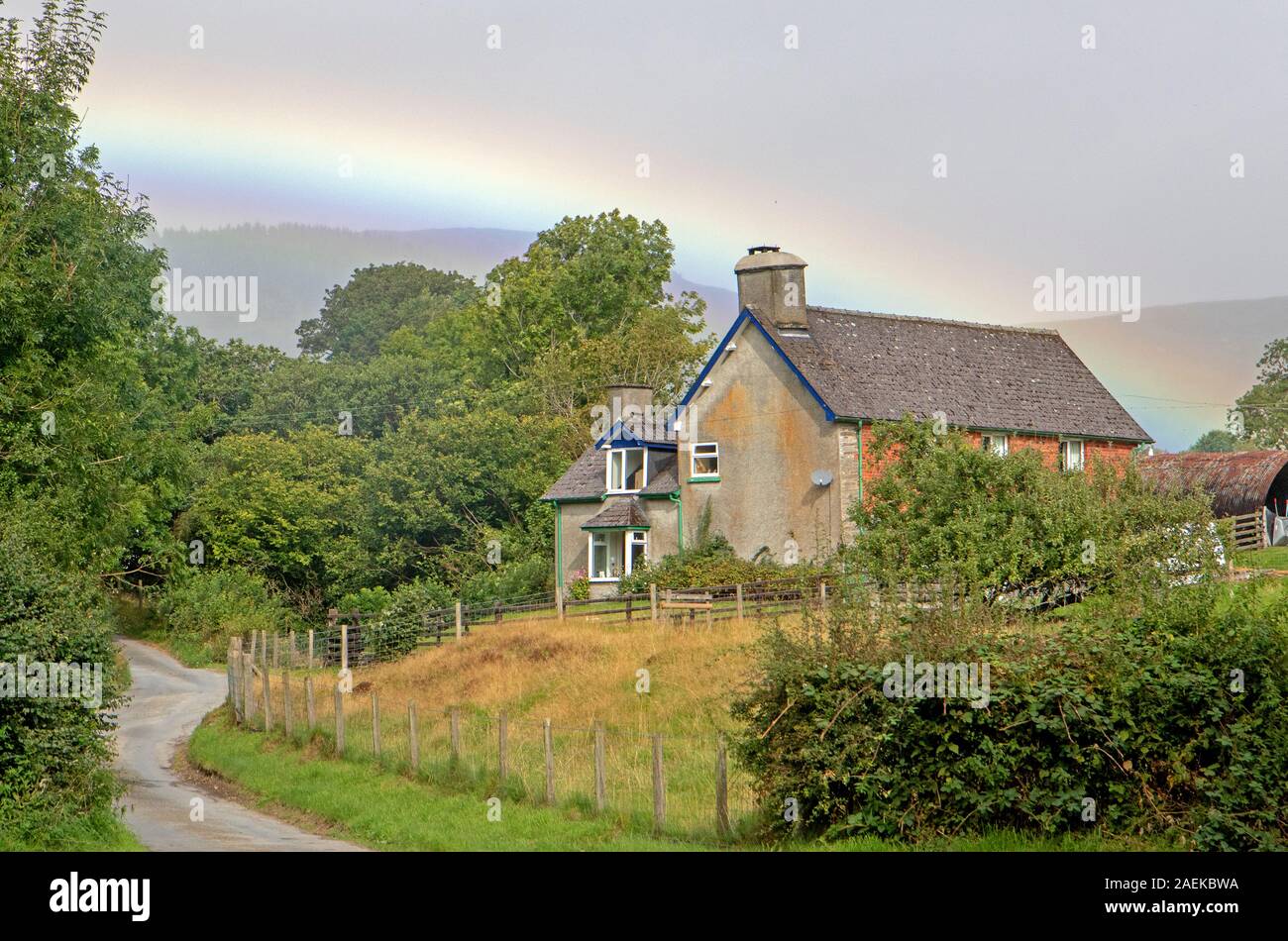 Farmhouse and rainbow neat Llanidloes Stock Photo