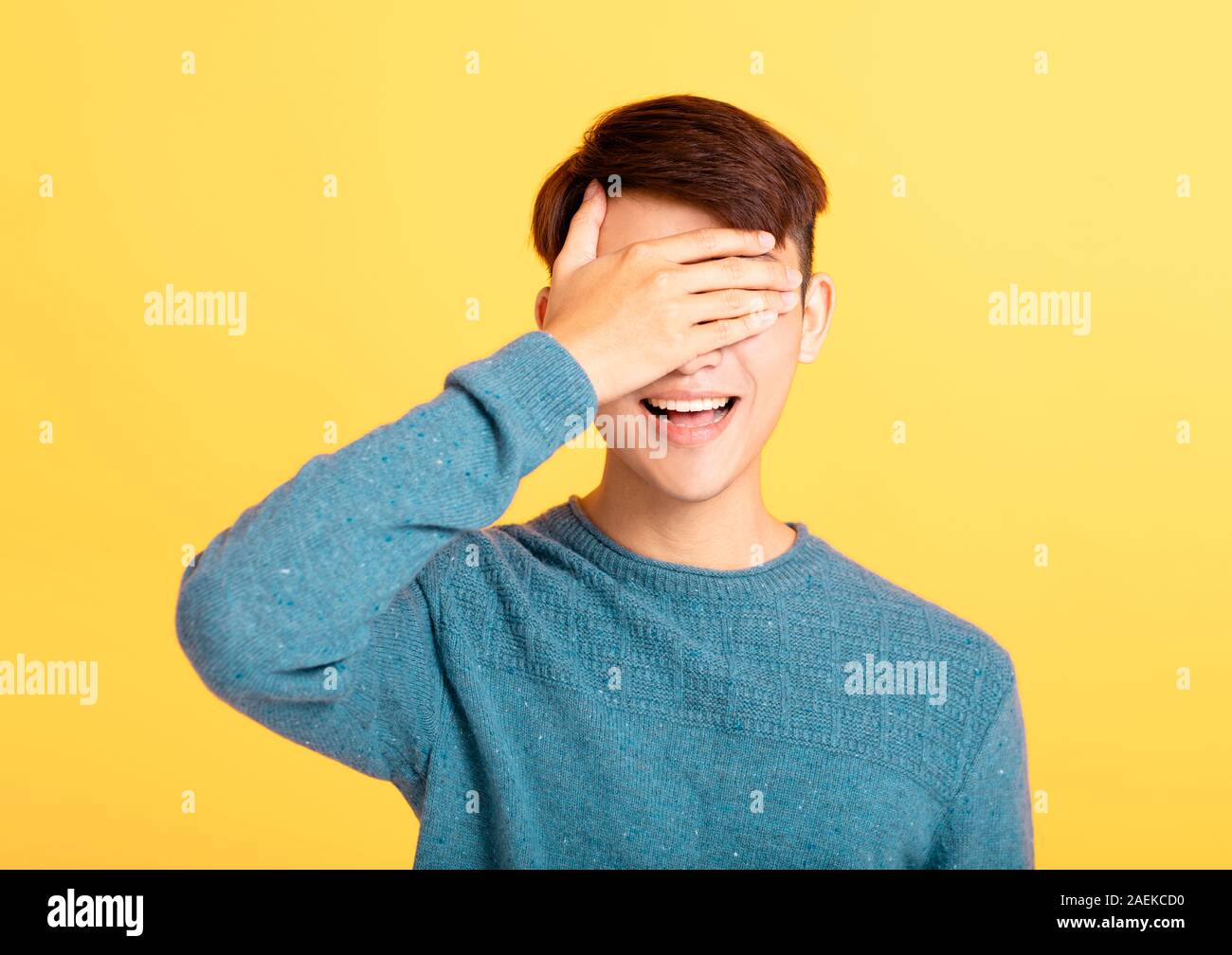 young man covering his eyes with hand Stock Photo