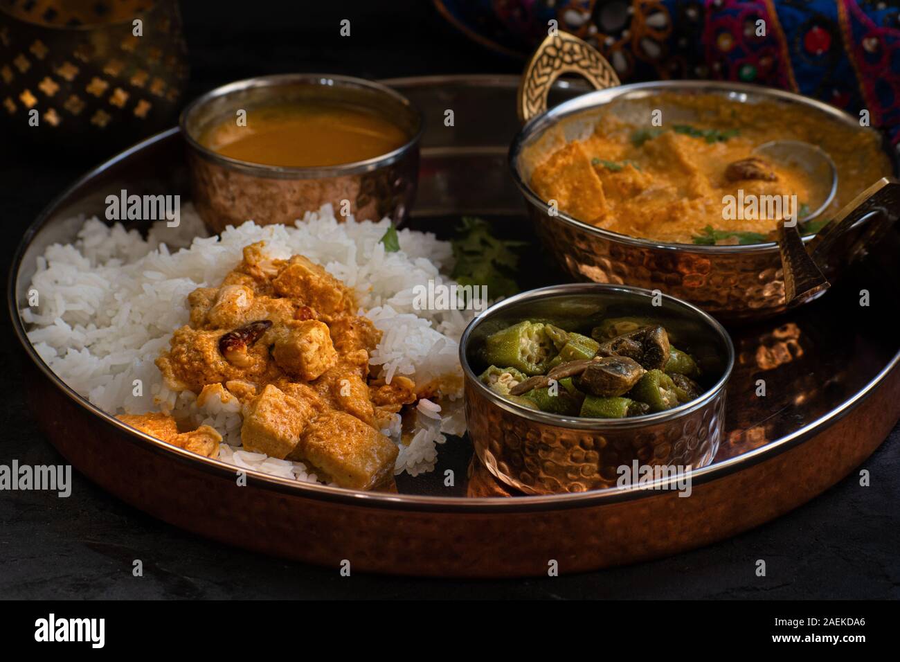 Indian paneer korma and rice served on copper platter Stock Photo