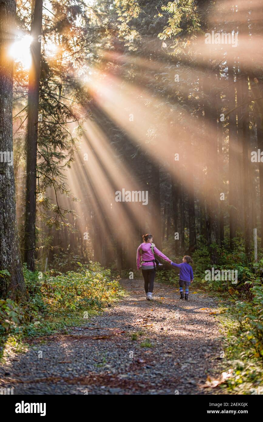 Asean mother and daughter walking in a forest Stock Photo