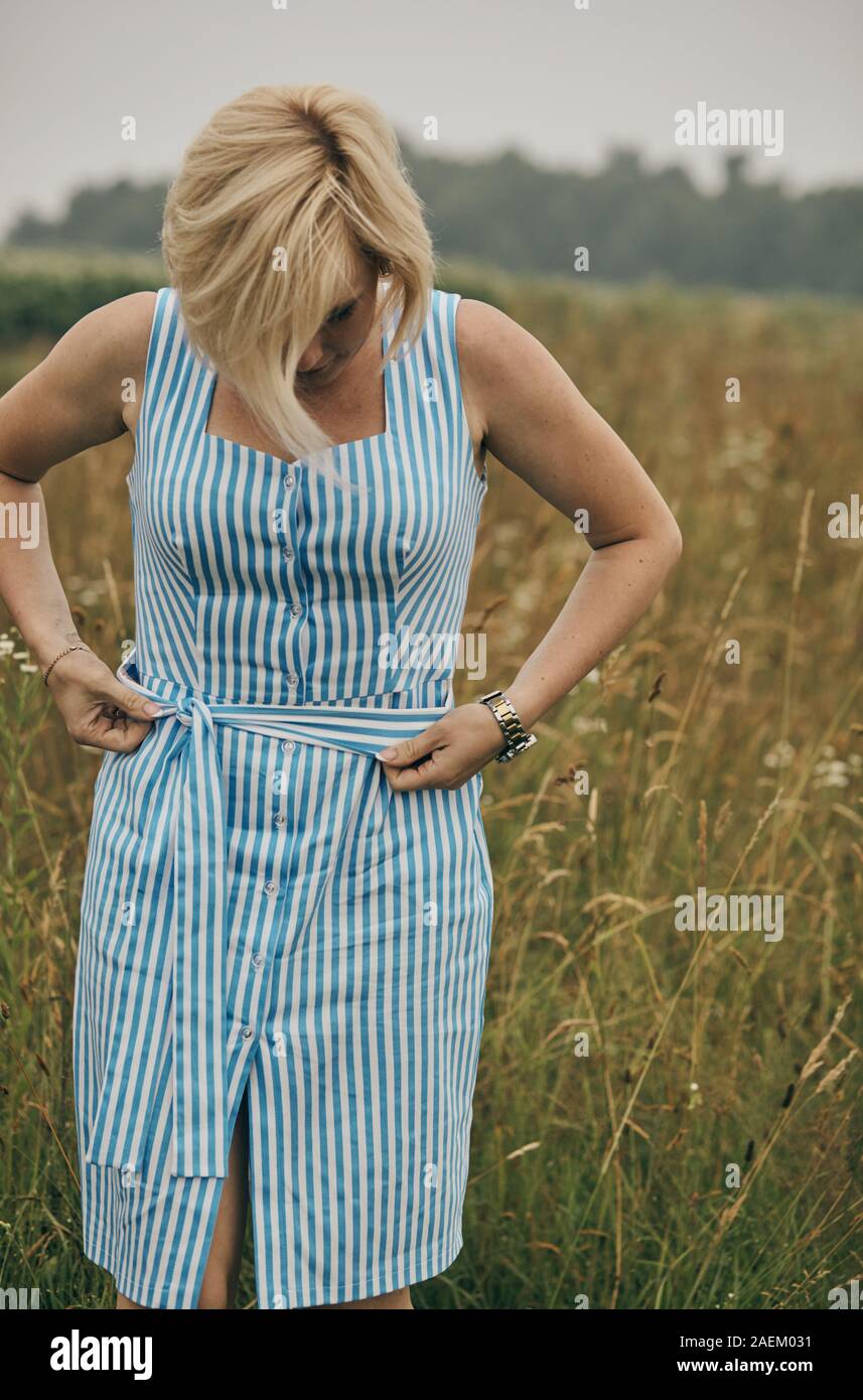 Happy woman relaxing in summer in beautiful field Stock Photo - Alamy