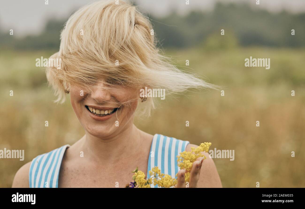 Happy woman relaxing in summer in beautiful field. Stock Photo