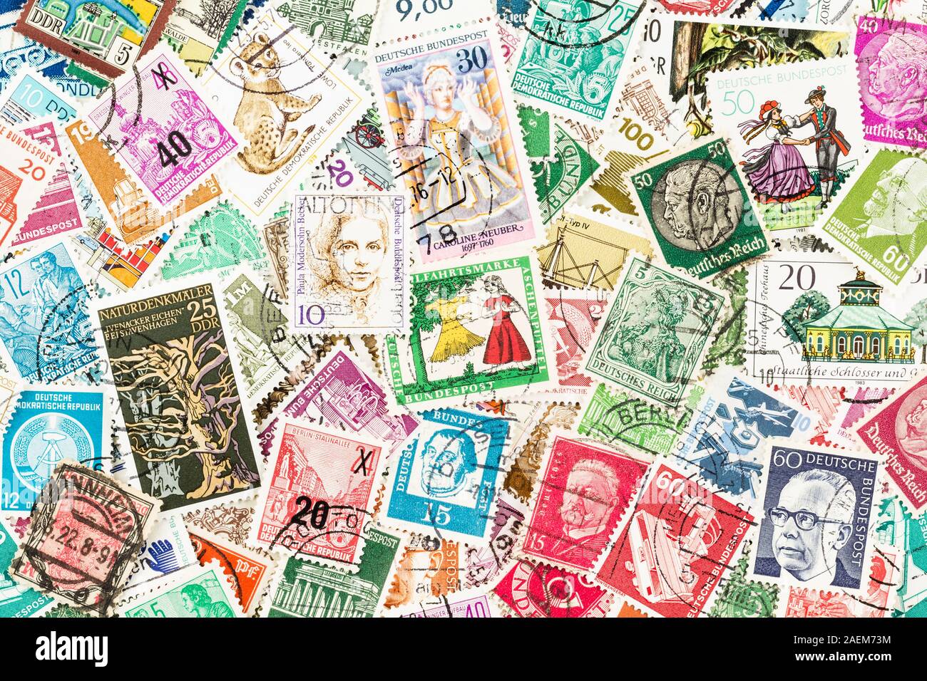 SEATTLE WASHINGTON - December 5, 2019:  Scattered used stamps of East and West Germany - Democratic and Federal Republics, Eastern and Western Bloc. Stock Photo