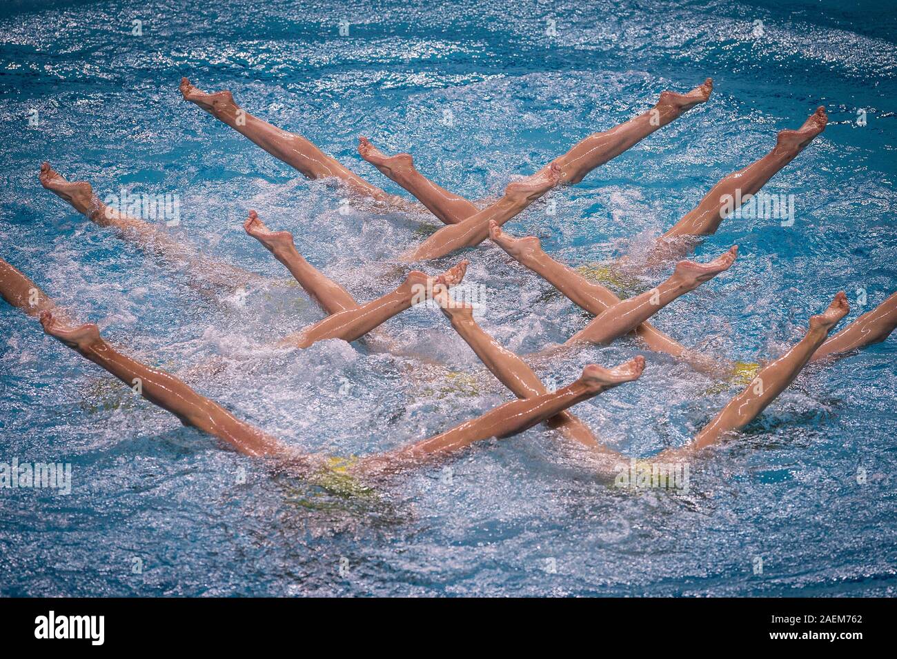 Swimmers do water ballet at the free combination synchronized swimming