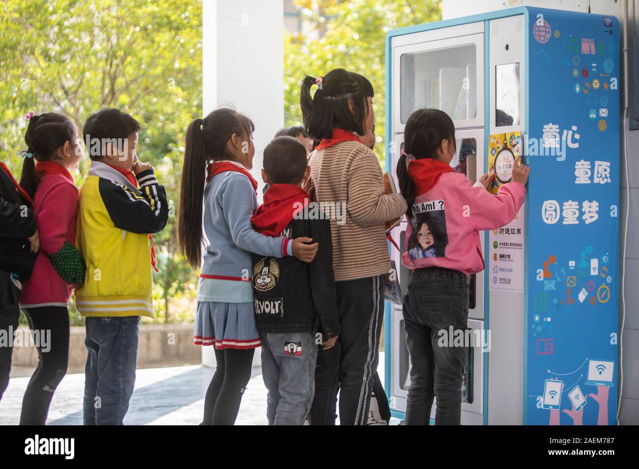 Kids return books to the book-rental machine in the primary school in Hangzhou city, east China's Zhejiang province, 5 November 2019.   Auto book rent Stock Photo