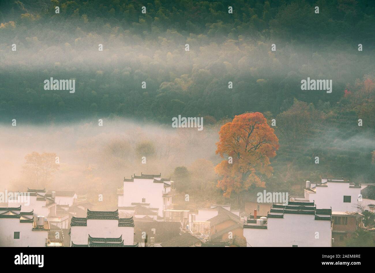 A view of traditional village fraught of Hui-style buildings in the mist in the sunshine in Shicheng ancient village, Wuyuan county, Shangrao city, ea Stock Photo