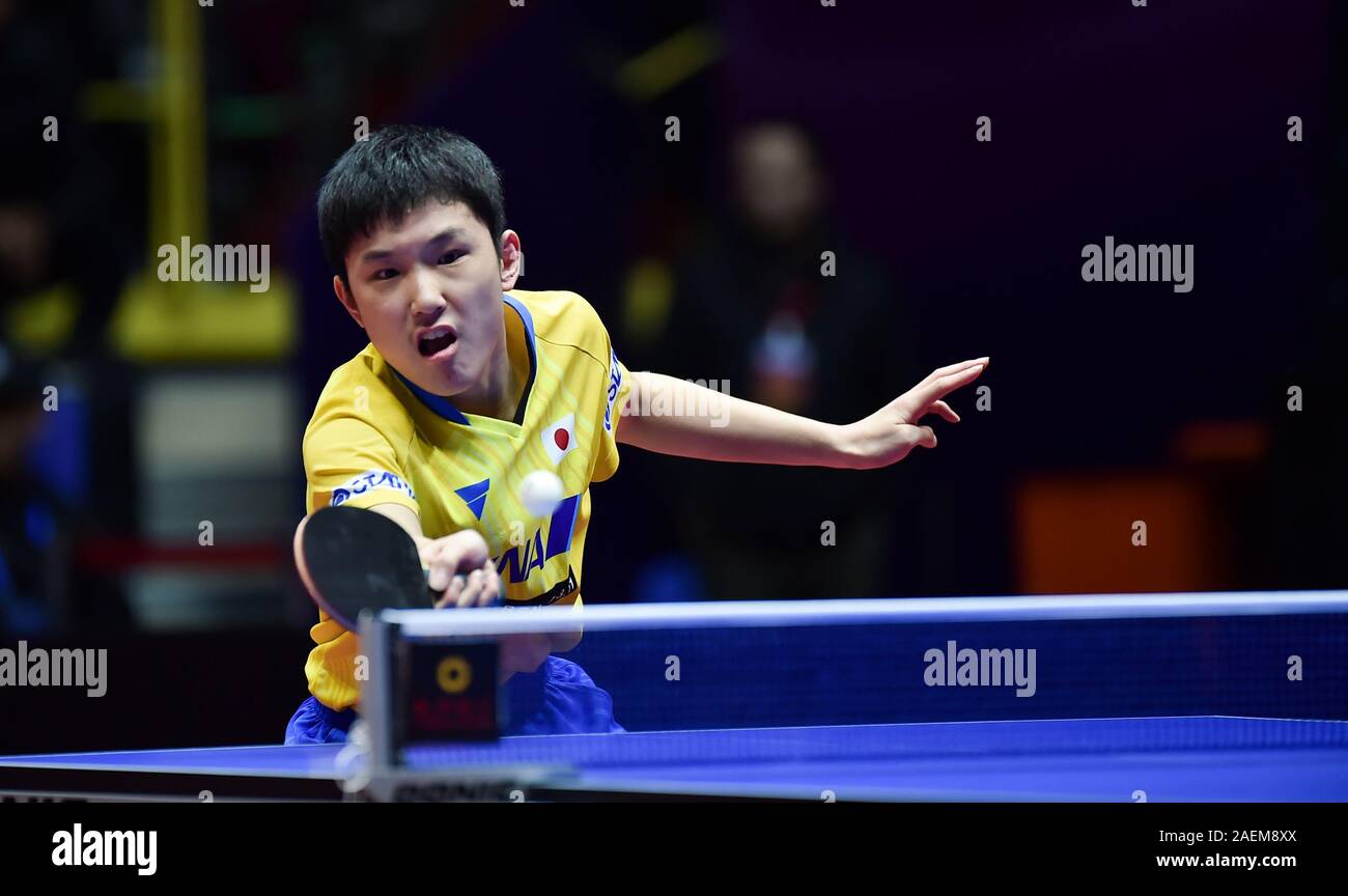 Harimoto Tomokazu of Japan gets the ball against Aruna Quadri of