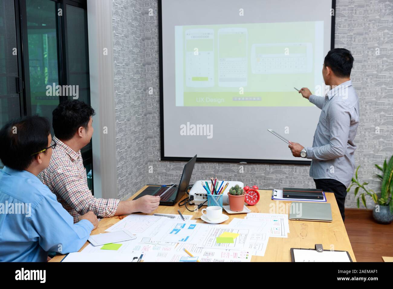 Graphic designers work together with UX UI designer planning application template layout framework for mobile phone computer mobile Stock Photo