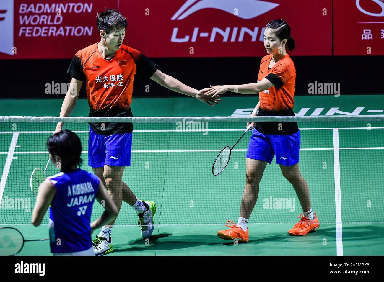 Ren Xiaoyu and Zhou Chaomin of China get the ball against Kouhei Gondou and Ayane Kurihara of Japan at the first round of mixed doubles of Fuzhou Chin Stock Photo