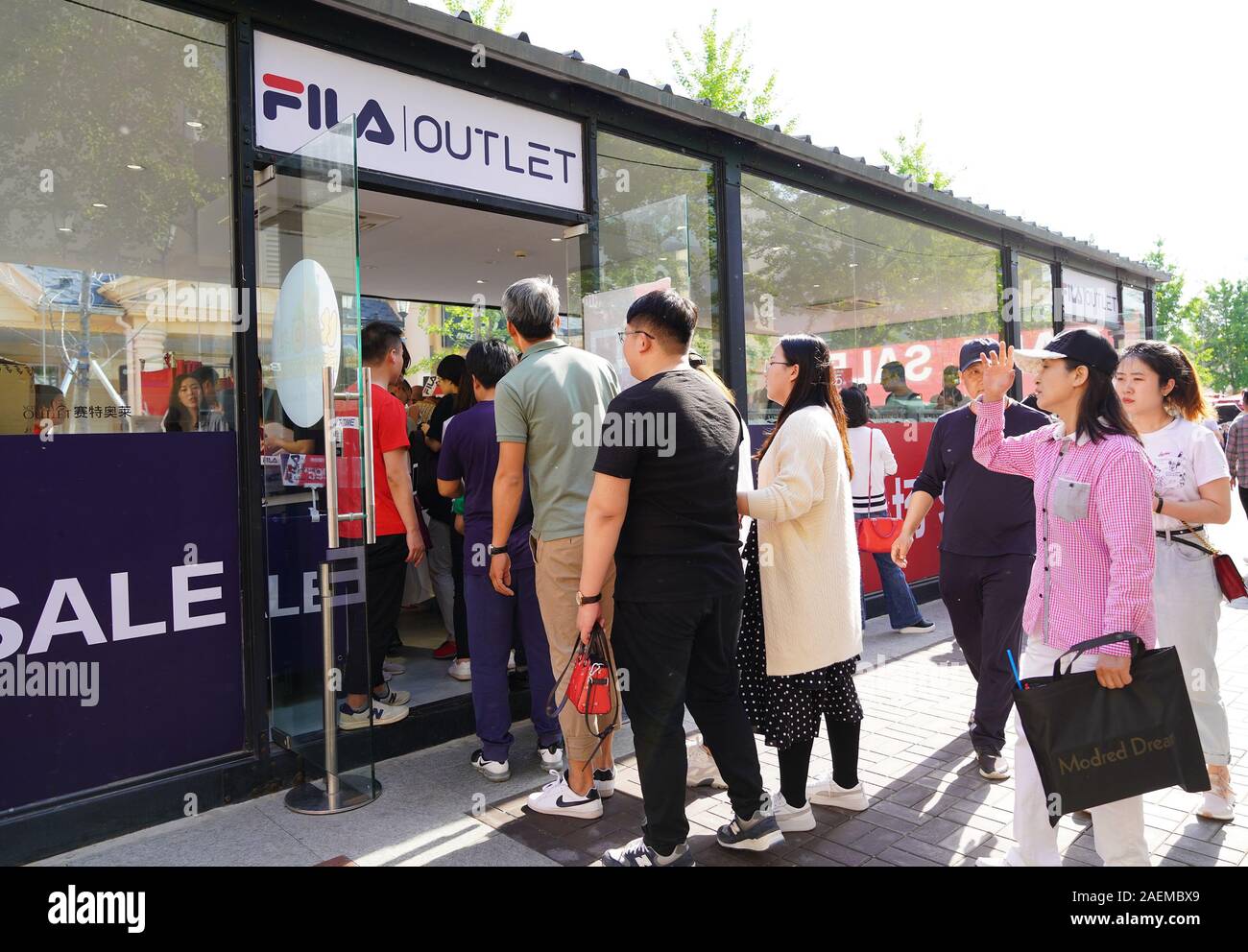 --File--People line up at an Outlet store in Beijing, China, 12 May 2019. According to the 'Post-95 Generation Credit Card Spending Report' issued by Stock Photo