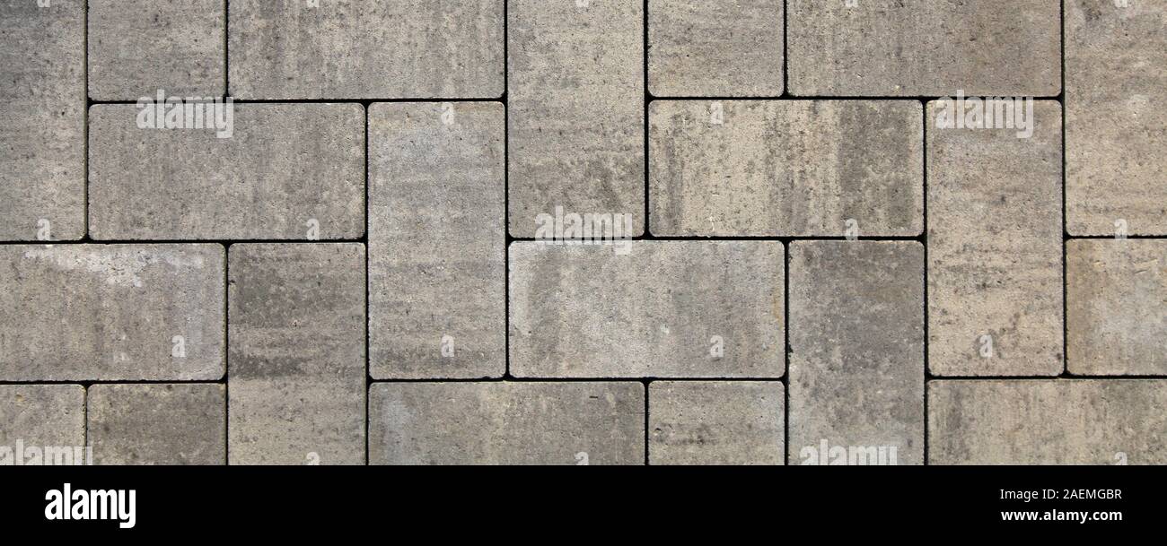 Regular shape blocks, texture, background. Paving slabs of gray blocks of flat shape, close-up. New pavement in the city park Stock Photo