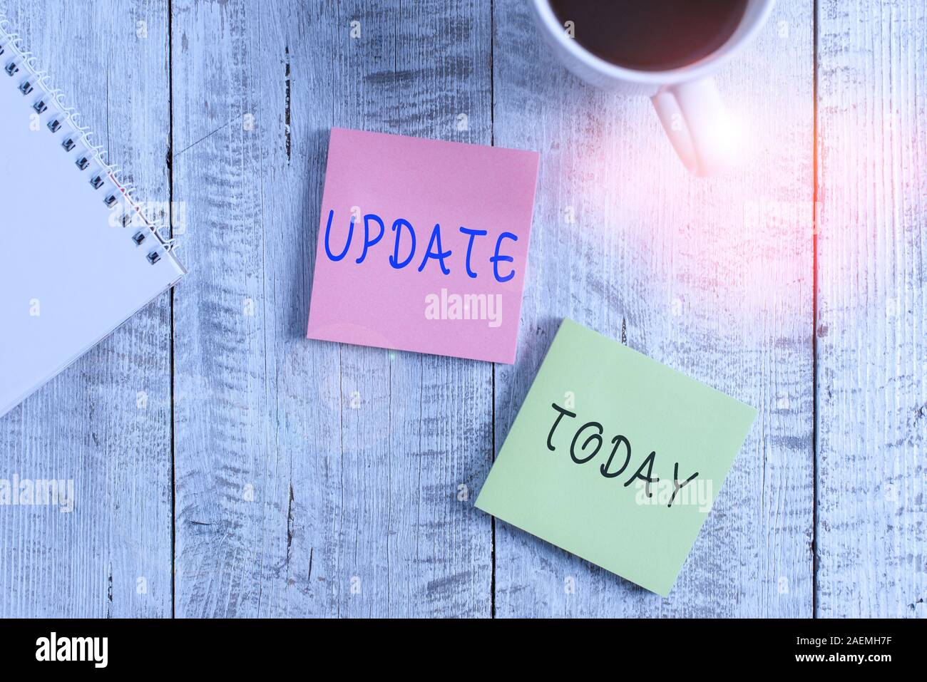 Text sign showing Update. Business photo showcasing by adding new information or making corrections Up to date Stationary placed next to a cup of blac Stock Photo