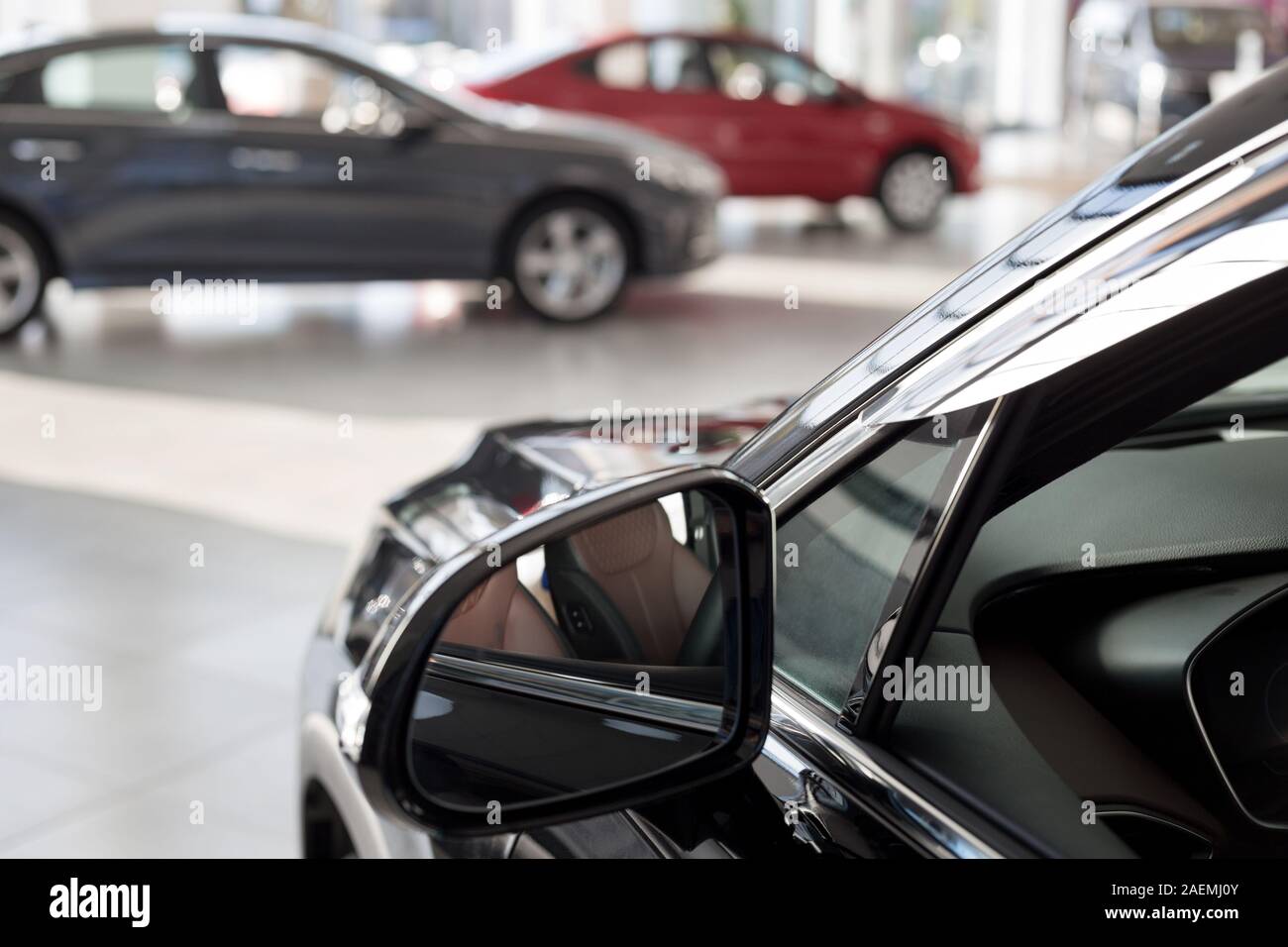 New cars at dealer showroom. Themed blur background with bokeh effect. Car auto dealership. Prestigious vehicles. Stock Photo