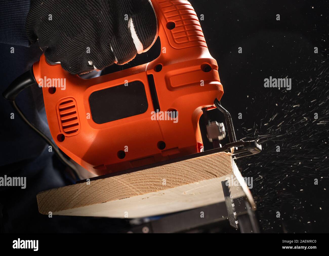 A carpenter worknig with jig saw and wood Stock Photo