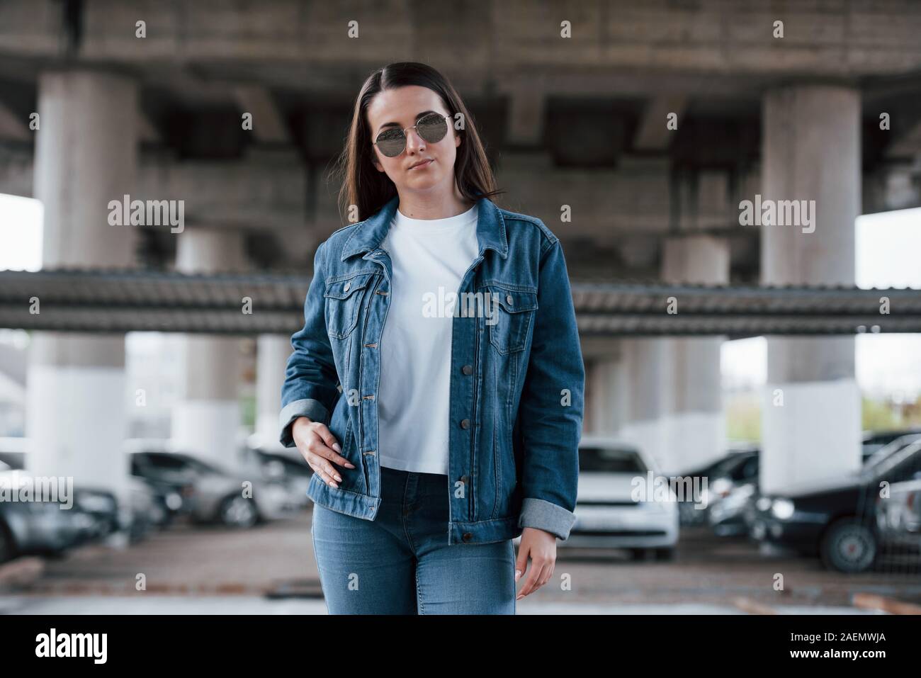 One person only. Portrait of beautiful young woman standing under the bridge outdoors Stock Photo