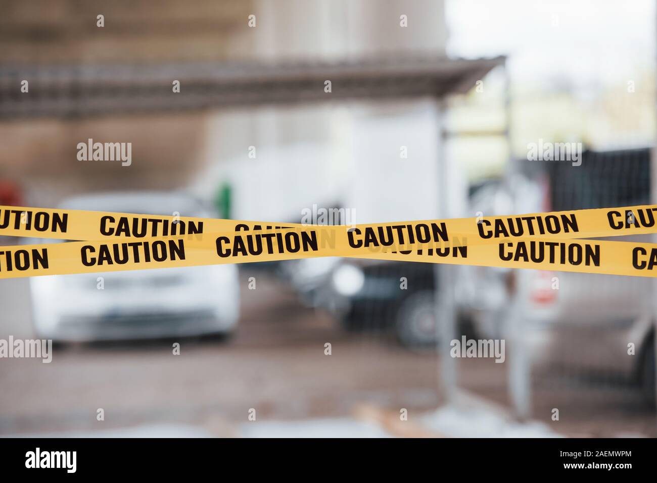 blurred-background-yellow-caution-tape-near-the-car-parking-lot-at