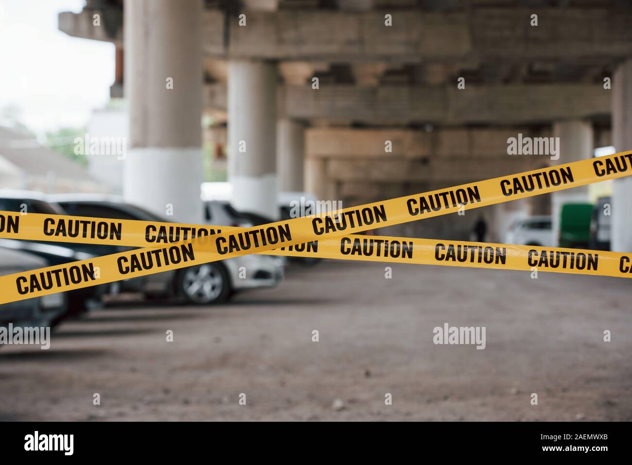 Many of vehicles. Yellow caution tape near the car parking lot at