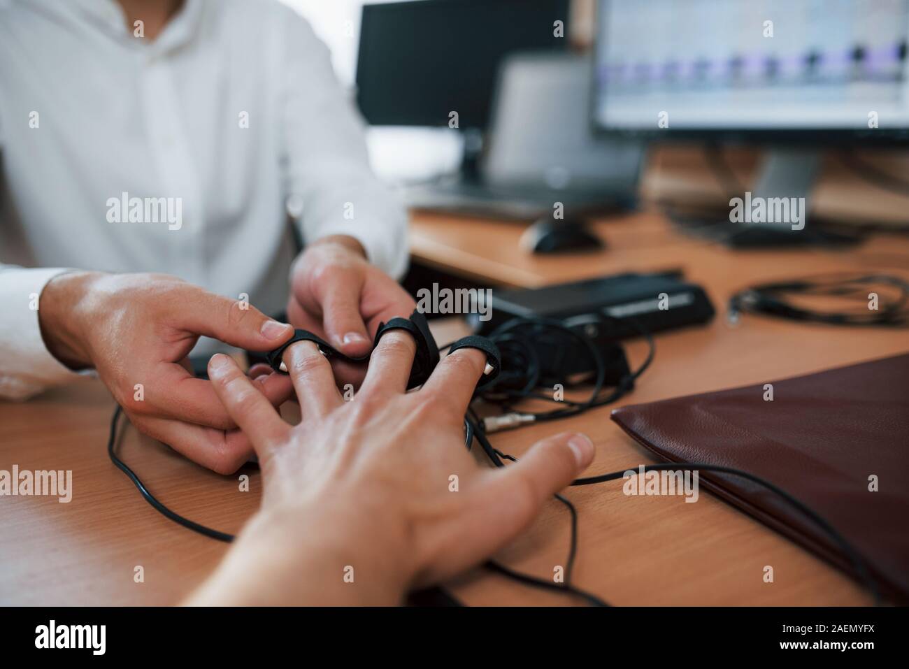 Giving the hand. Preparation for the polygraph test. Conception of the lie detector Stock Photo