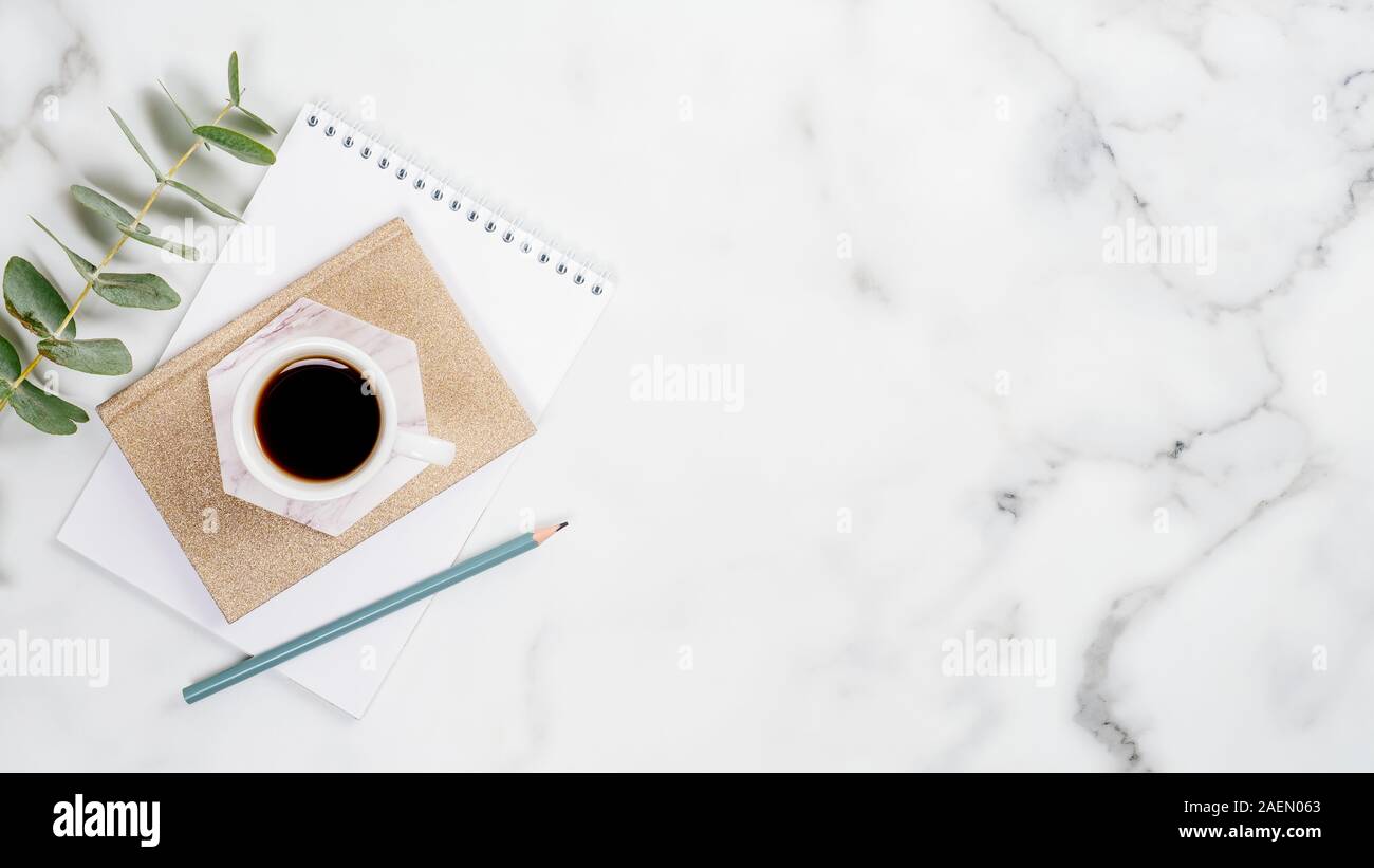 Home Office Desk With Paper Notepad Cup Of Coffee And Eucalyptus