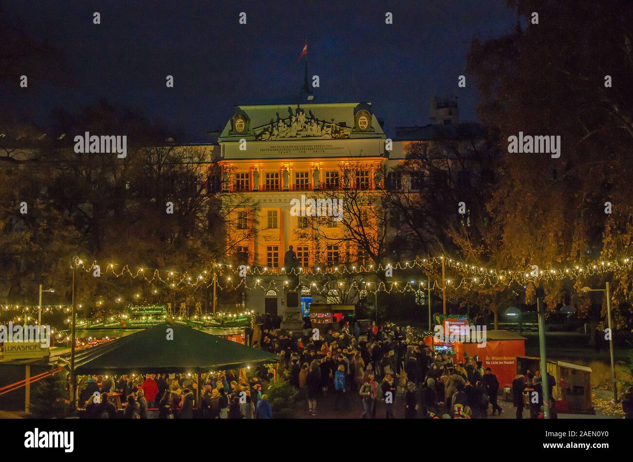 Vienna Christmas markets have great settings. The Karlsplatz version is no exception, nestled in front of Karlskirche and the Technische Universität. Stock Photo