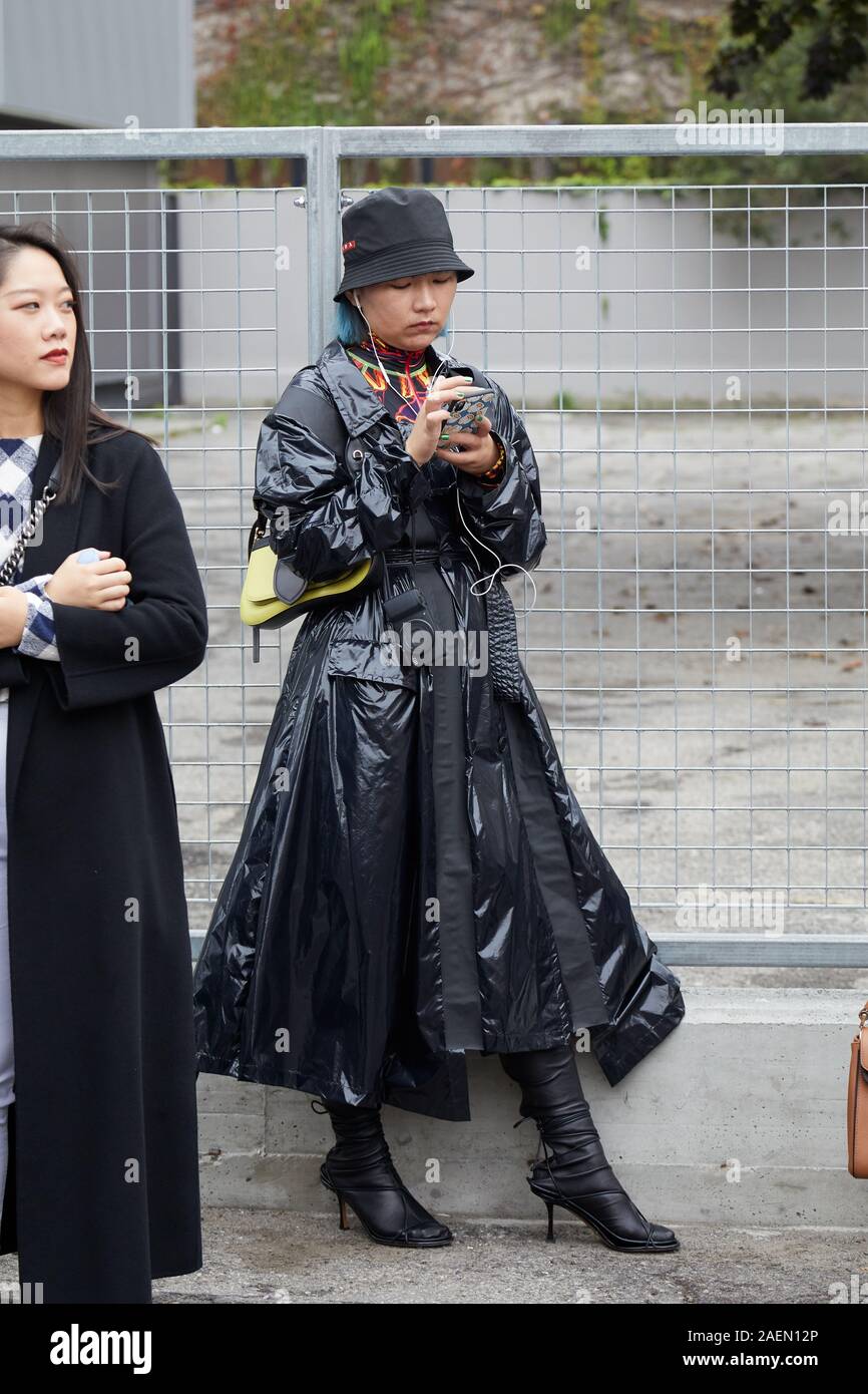 MILAN, ITALY - SEPTEMBER 22, 2019: Woman with black raincoat and Prada hat  before Fila fashion show, Milan Fashion Week street style Stock Photo -  Alamy